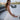 Girl wearing Amara white one piece mini dress with bow back