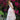 Woman in a pink dress standing in front of pink flowers
